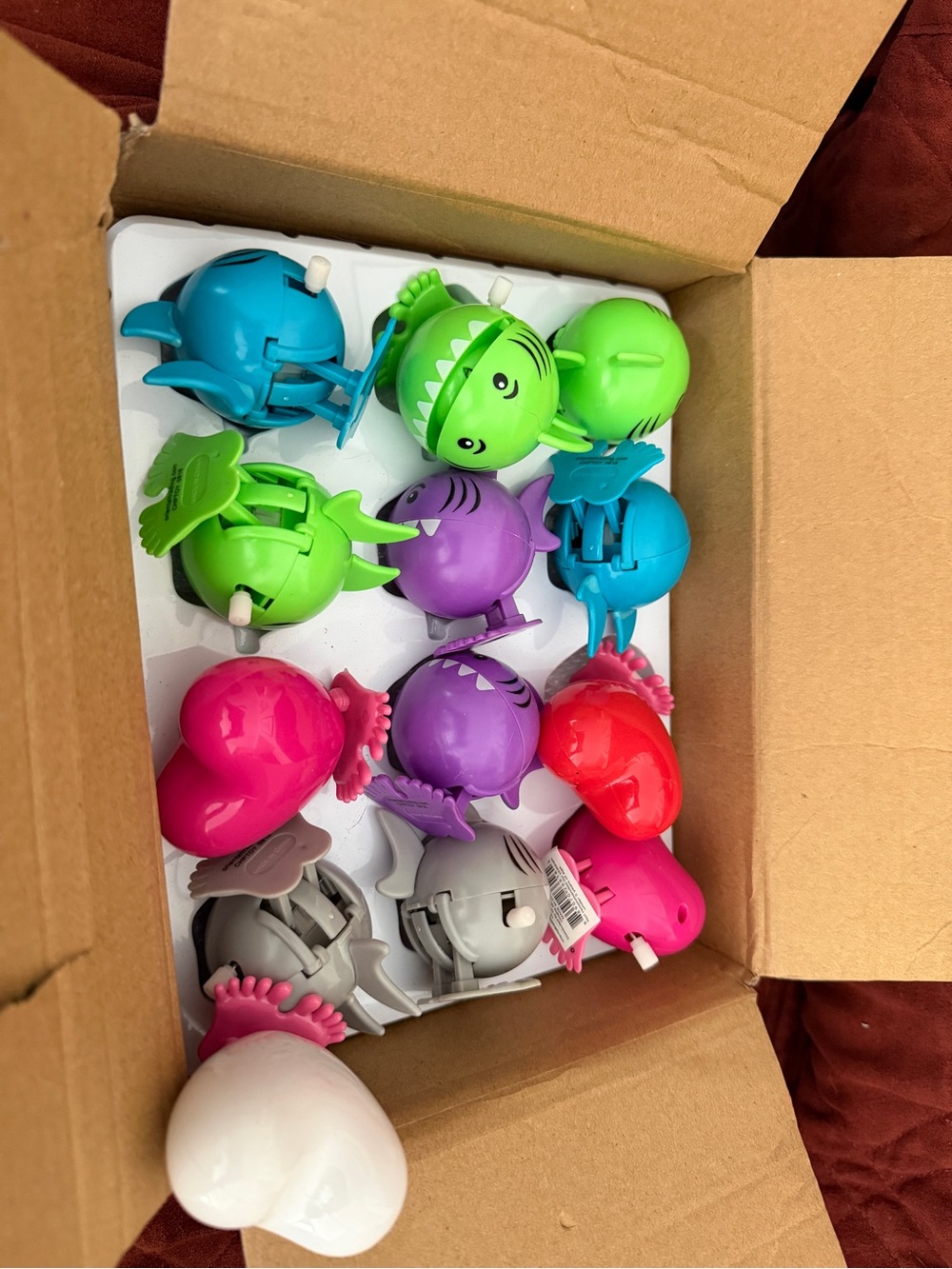 Assorted colors of sharks and hearts wind up toys .